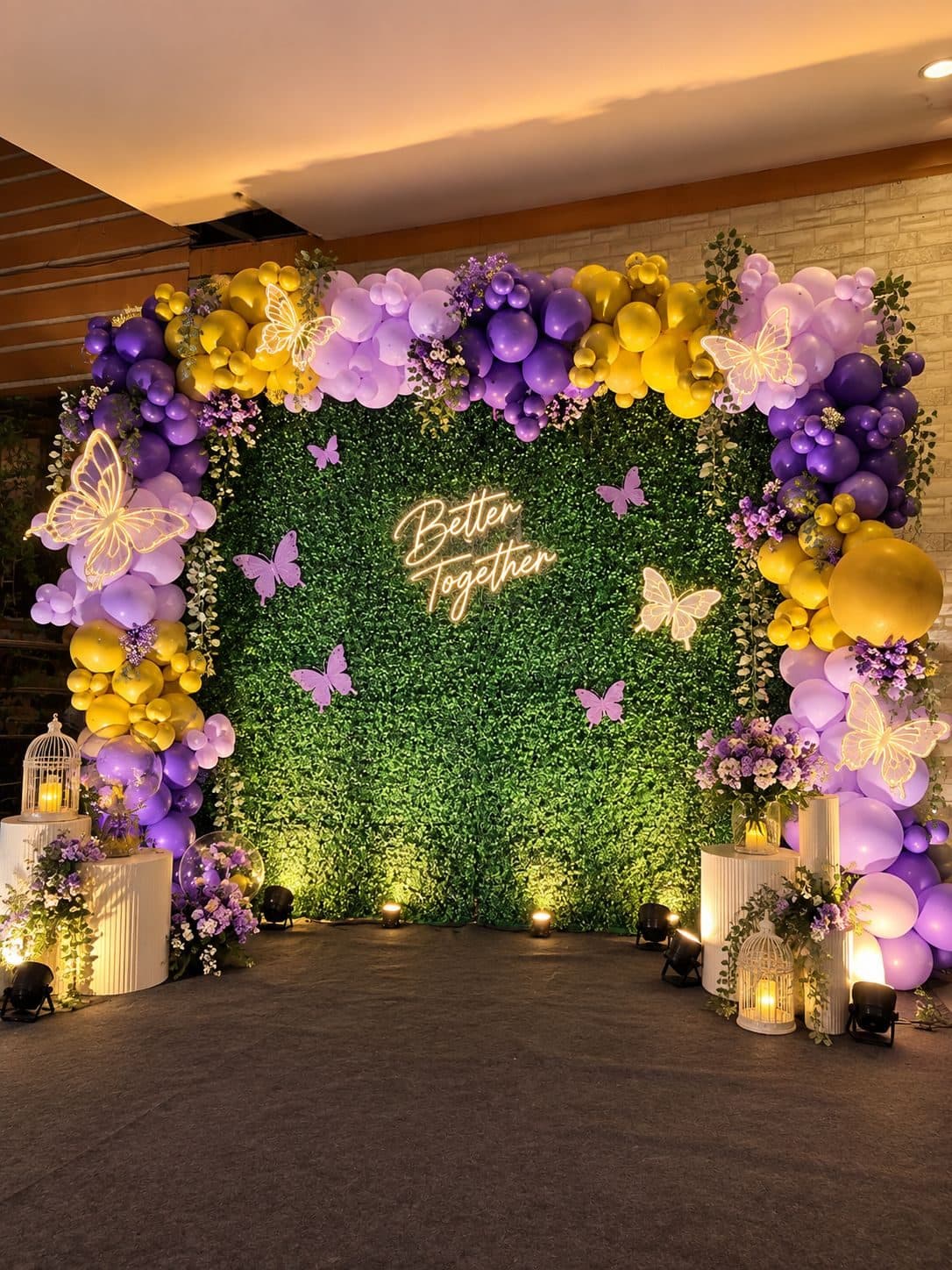 Purple, lilac and gold butterfly balloon arch with a Better Together neon sign